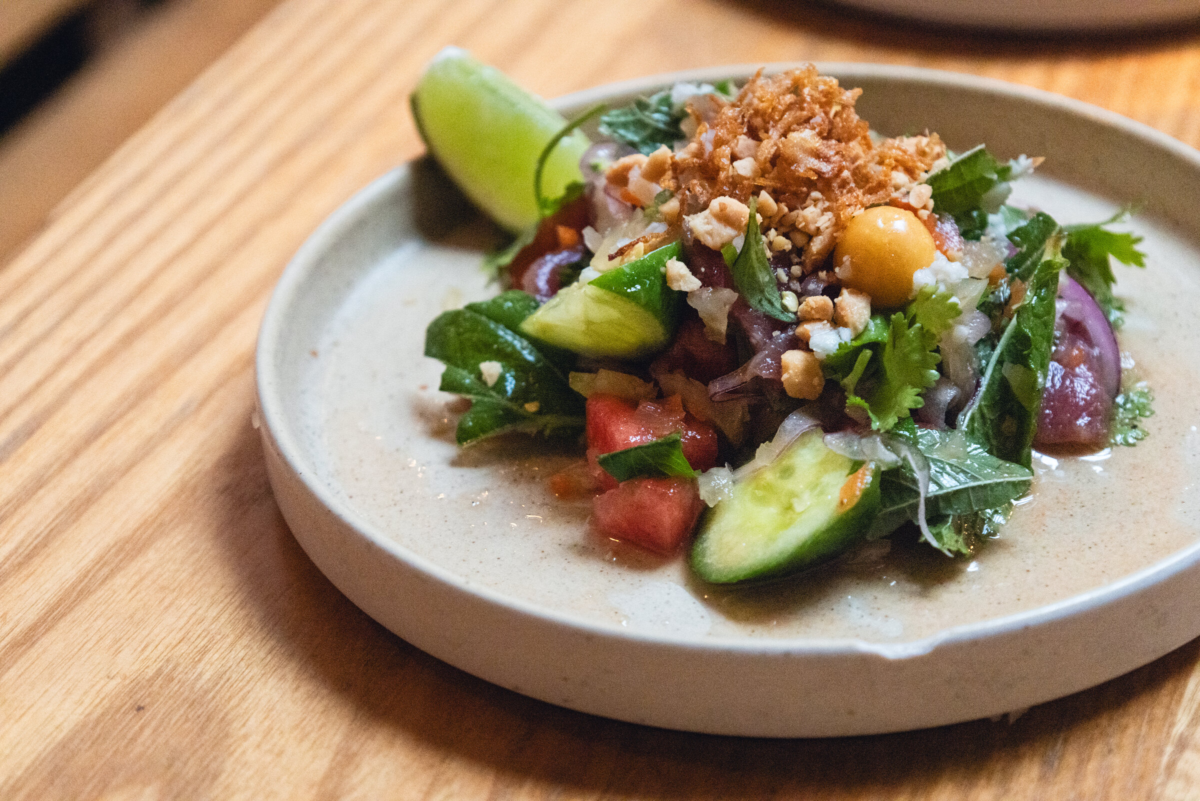 Close view of a colorful herb salad with lime and peanuts