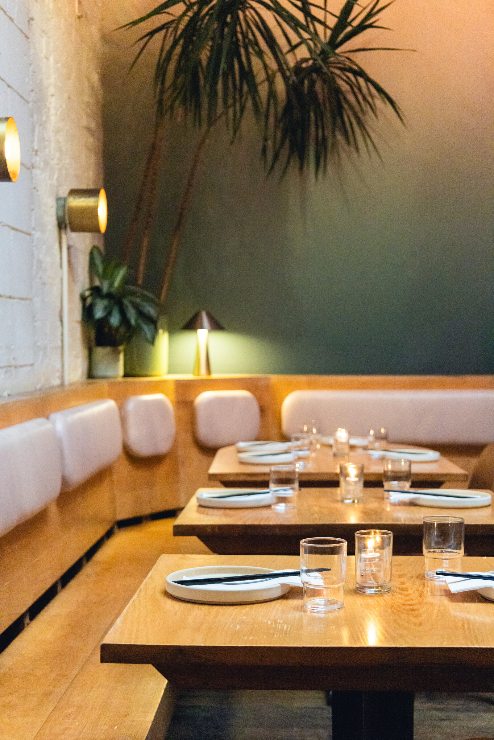 The softly lit Di An Di dining room set for service