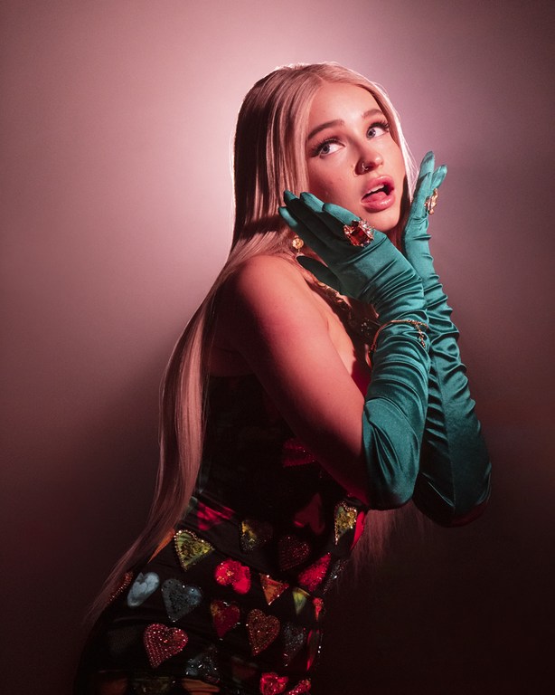 Kim Petras wearing long green gloves