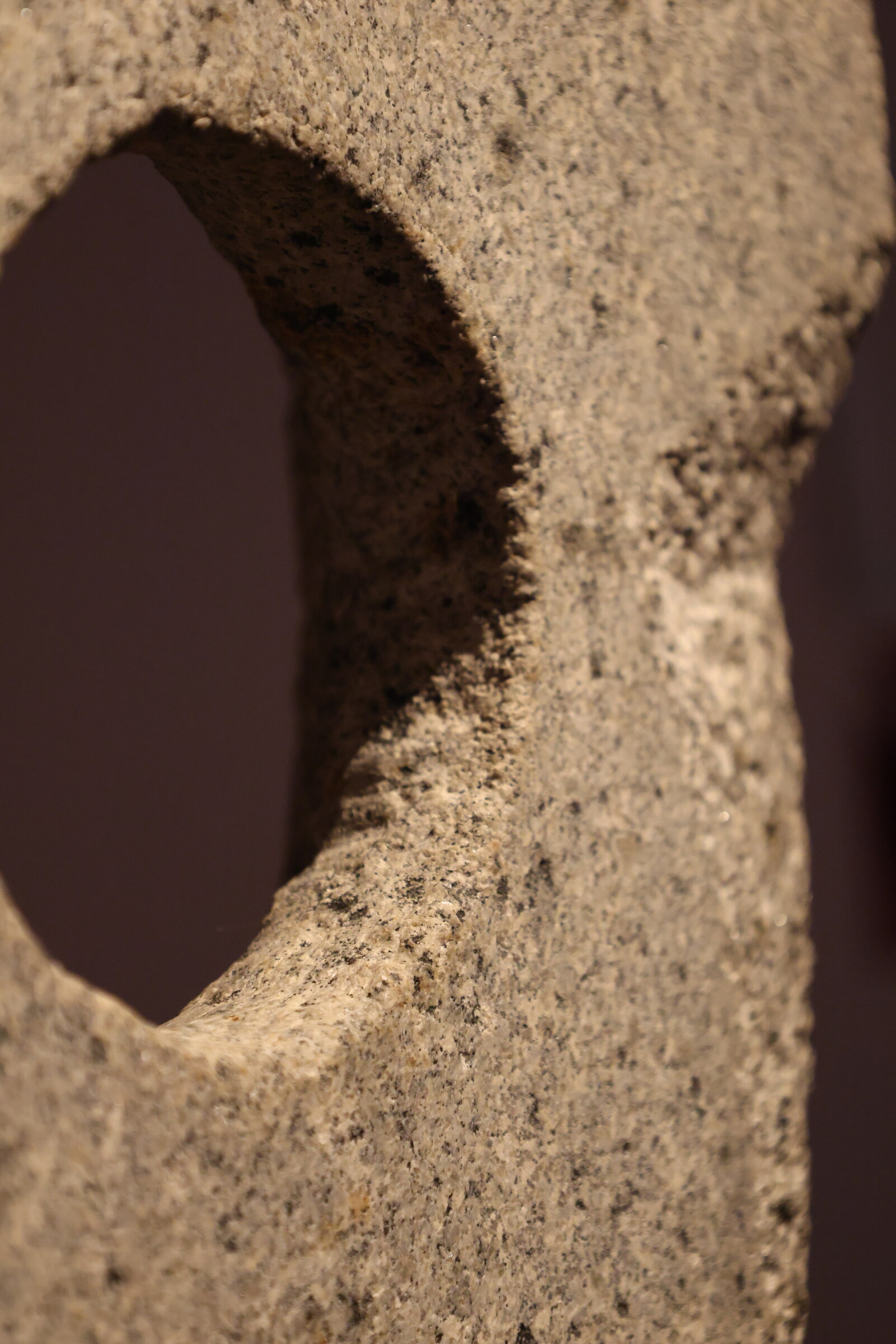 Close view of a carved opening and textured stone surface