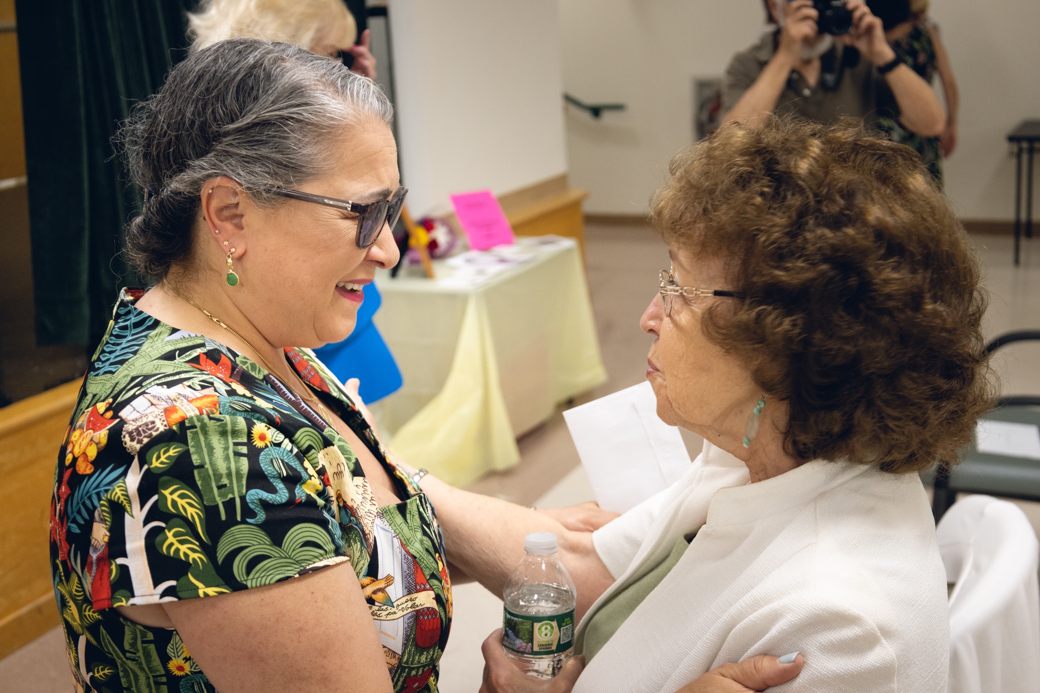Paula Curci speaking with an attendee after the event
