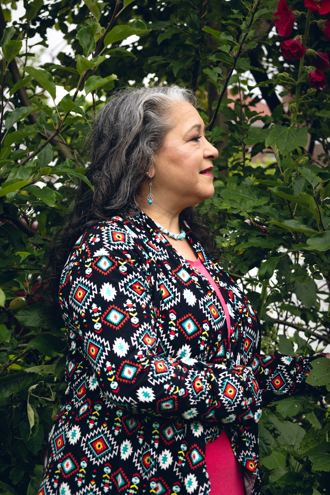 Profile portrait of Paula Curci in a garden