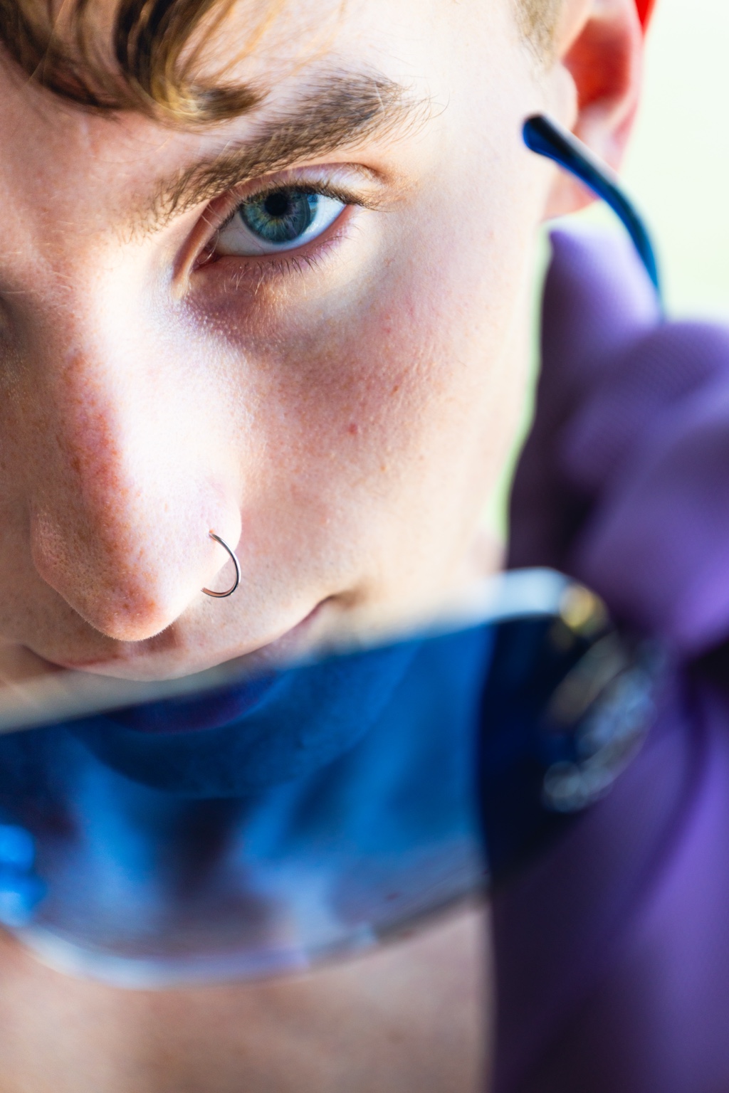 Close portrait of Ryder removing blue glasses