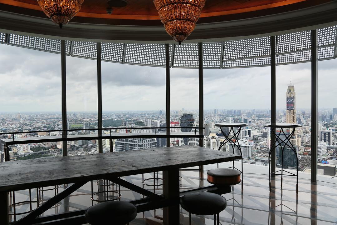 Champagne Bar seating framed by panoramic views of the Bangkok skyline