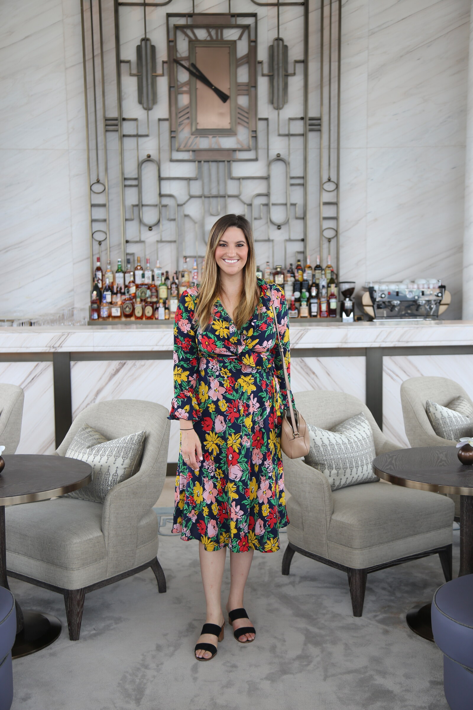 Guest wearing a floral dress photographed in the Clock Room at Waldorf Astoria Bangkok
