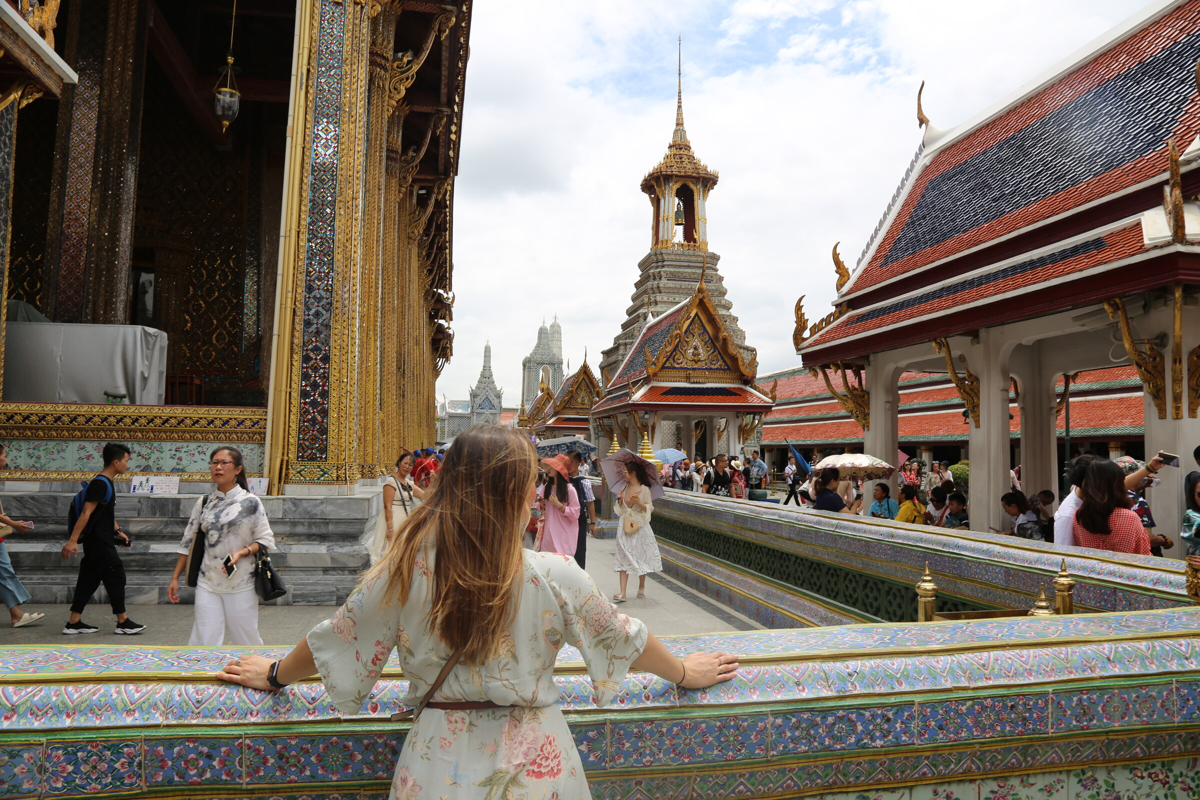 Visitor overlooking an ornate terrace at the Grand Palace in Bangkok