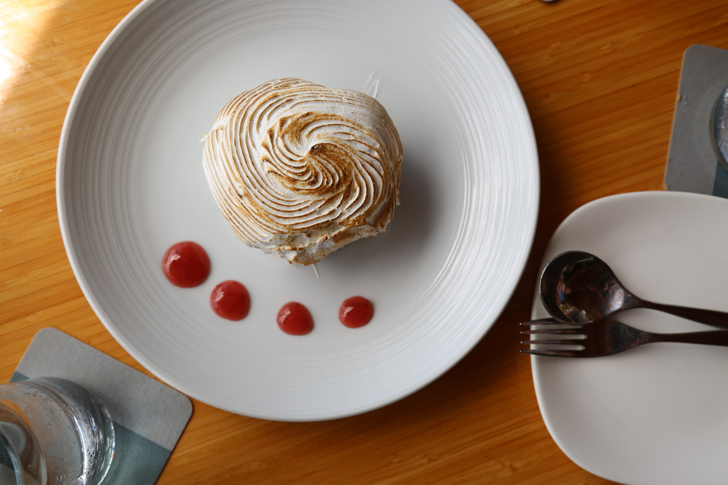 Overhead view of a toasted meringue dessert with berry sauce at Grand Wailea