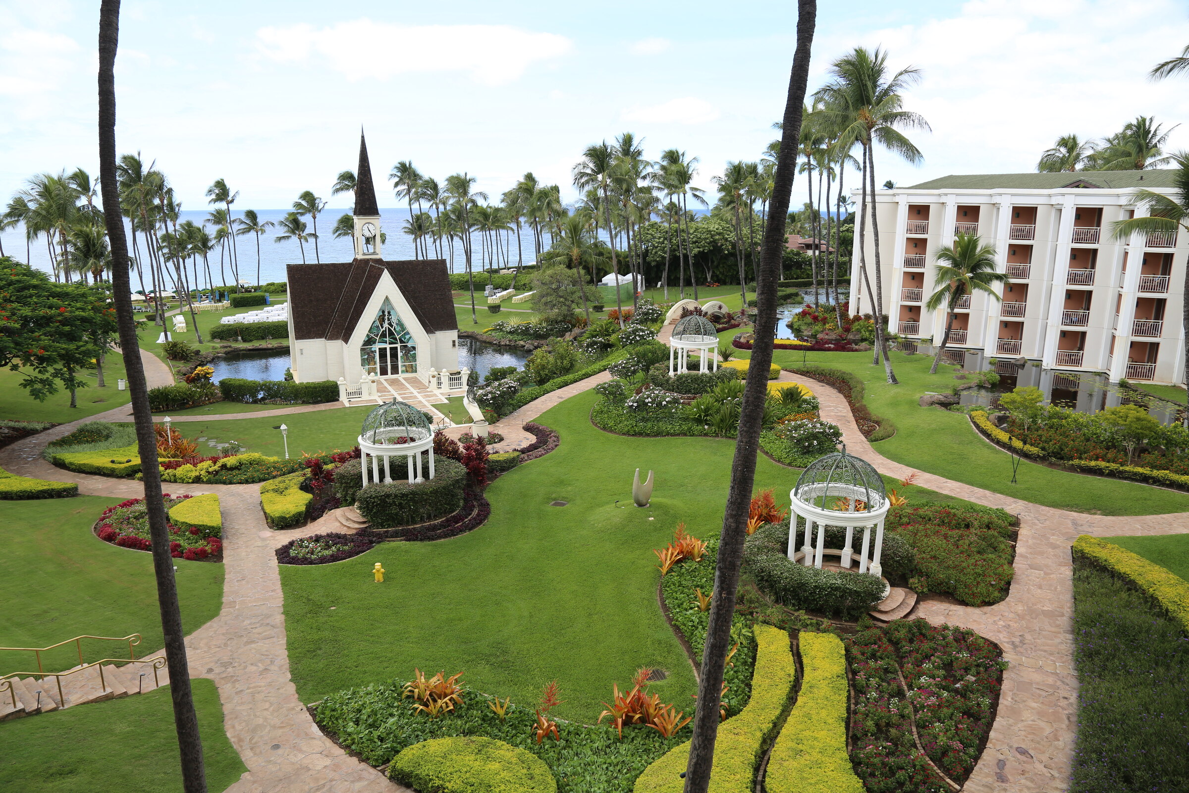 White chapel and garden gazebos across the landscaped grounds of Grand Wailea