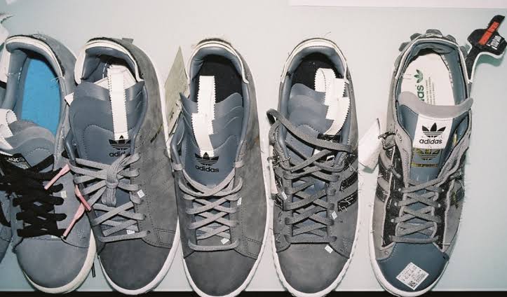Customized gray Adidas Campus 80s shoes arranged in a row